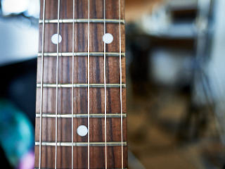 A closeup of a guitar neck.