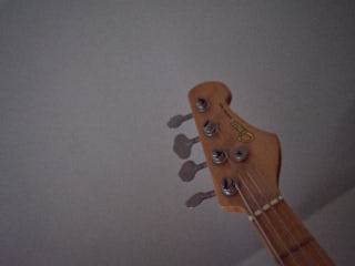 The headstock of a bass guitar.