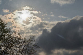 The sun behind a cloud.