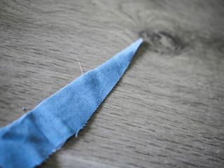 A piece of cloth formed like an arrow.